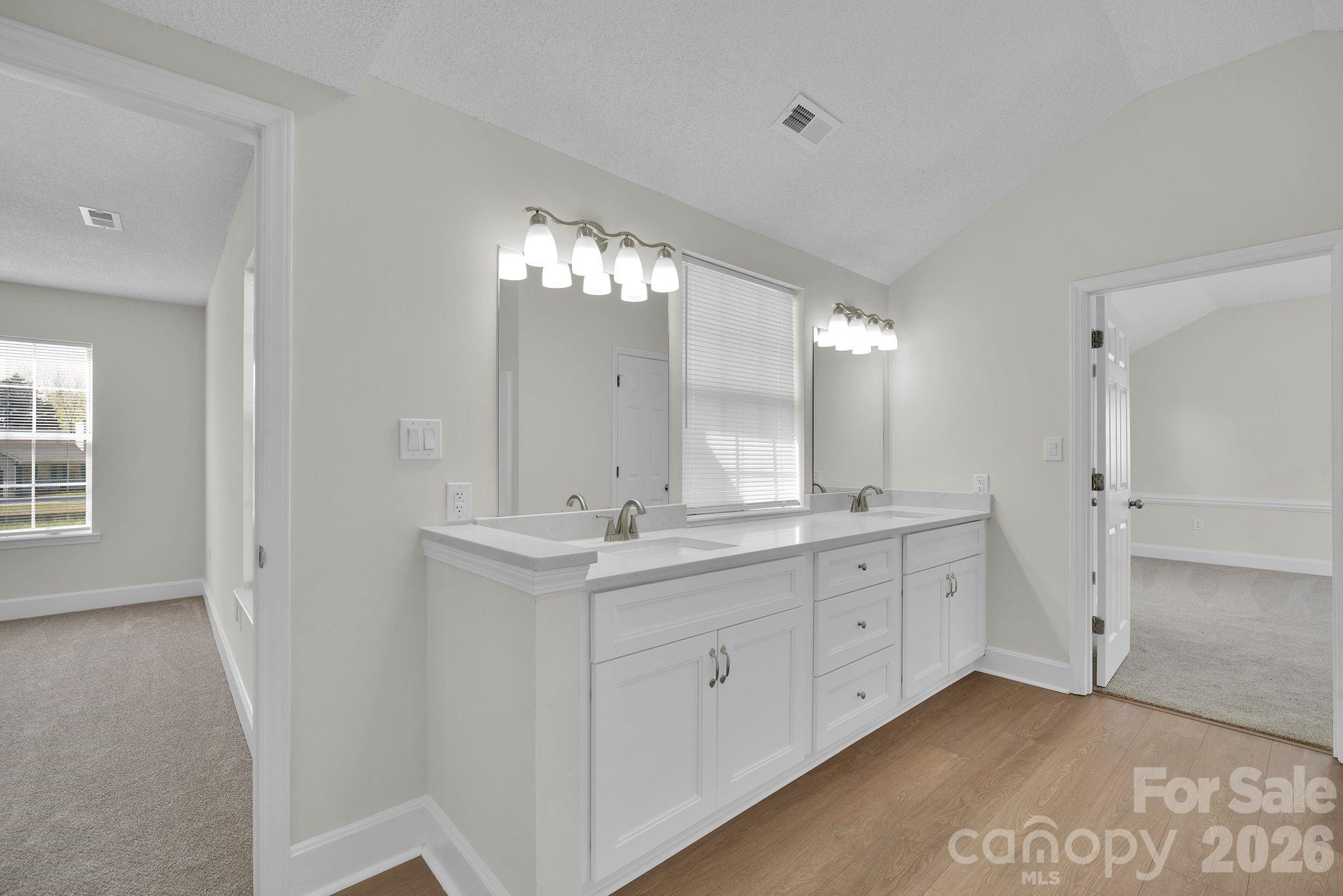 2720 Goldmine Road Monroe, NC 28110 - Photo 23 of 31 a bathroom with a double vanity sink and mirror