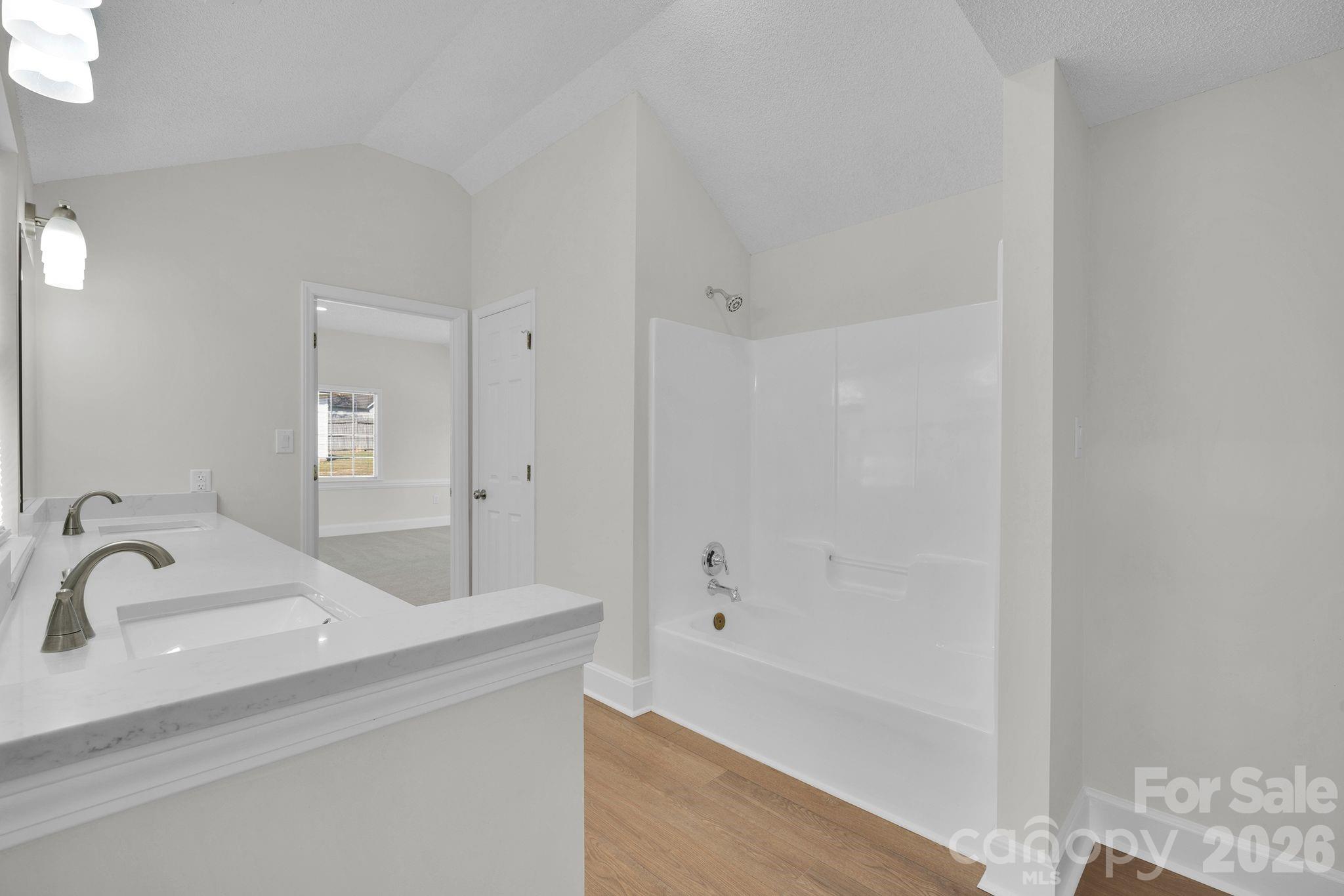 2720 Goldmine Road Monroe, NC 28110 - Photo 24 of 31 a bathroom with a bathtub and shower