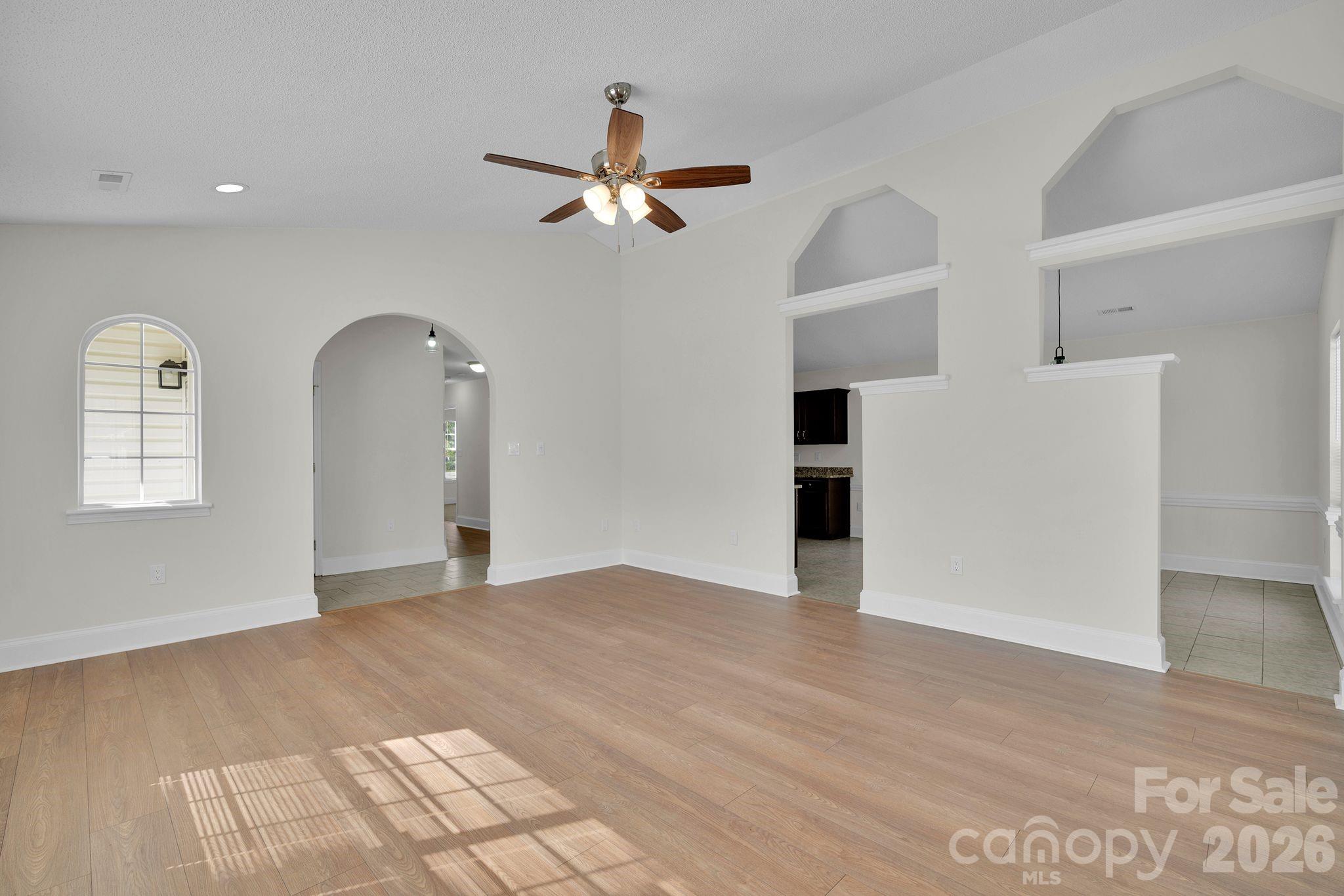 2720 Goldmine Road Monroe, NC 28110 - Photo 6 of 31 a view of empty room with wooden floor and ceiling fan