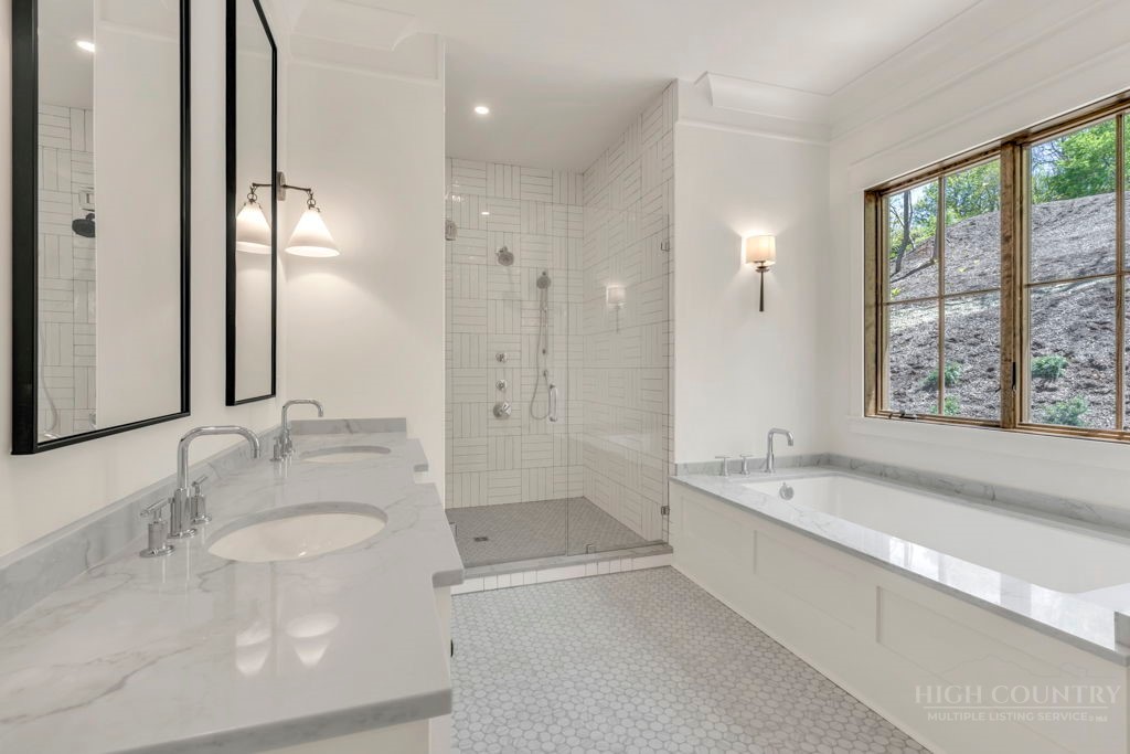 536 Boone Ridge Lane Boone, NC 28607 - Photo 27 of 50 a bathroom with a granite countertop tub sink and a mirror