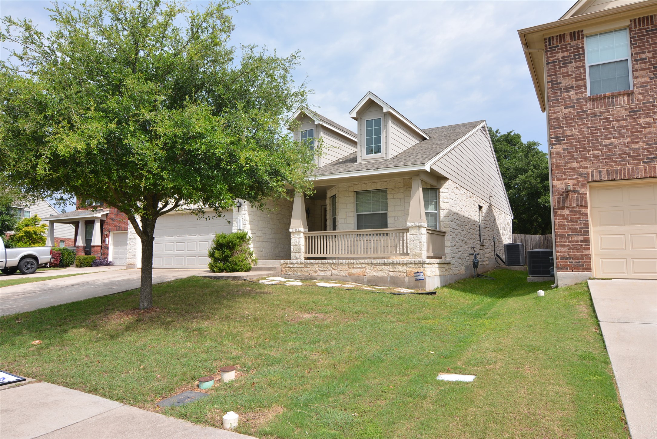 1303 Horseshoe Ranch Drive Leander, TX 78641 - Photo 1 of 26 A charming home boasts a welcoming front porch, a well-kept lawn, and an inviting stone facade.