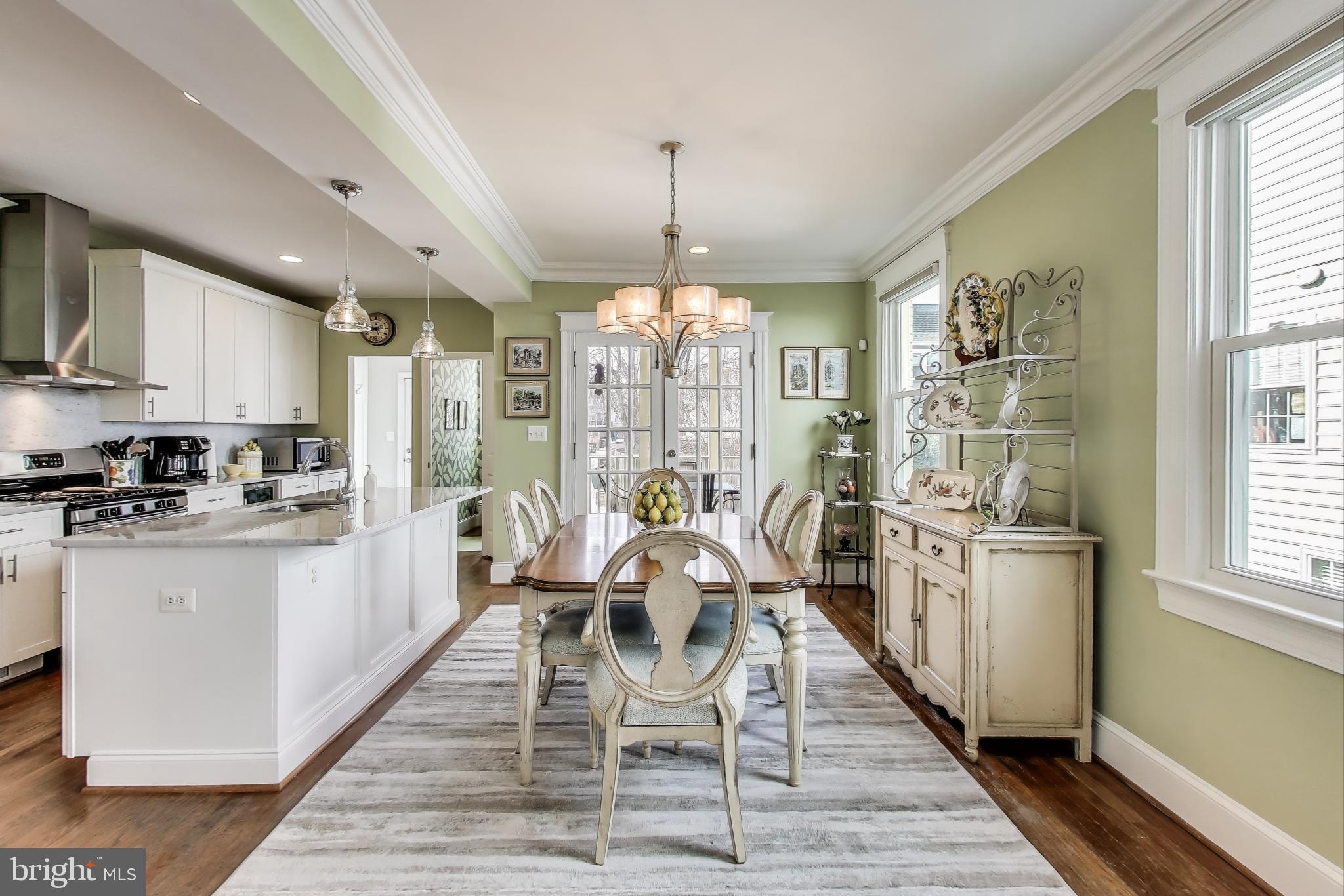5708 4th Street Northwest Washington, DC 20011 - Photo 9 of 53 a kitchen with stainless steel appliances granite countertop a stove top oven a refrigerator a sink dishwasher with a dining table and chairs