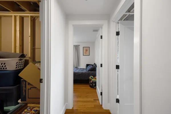 a view of a hallway with couch and closet