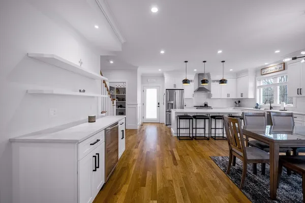 a large kitchen with stainless steel appliances kitchen island granite countertop a large island in the center