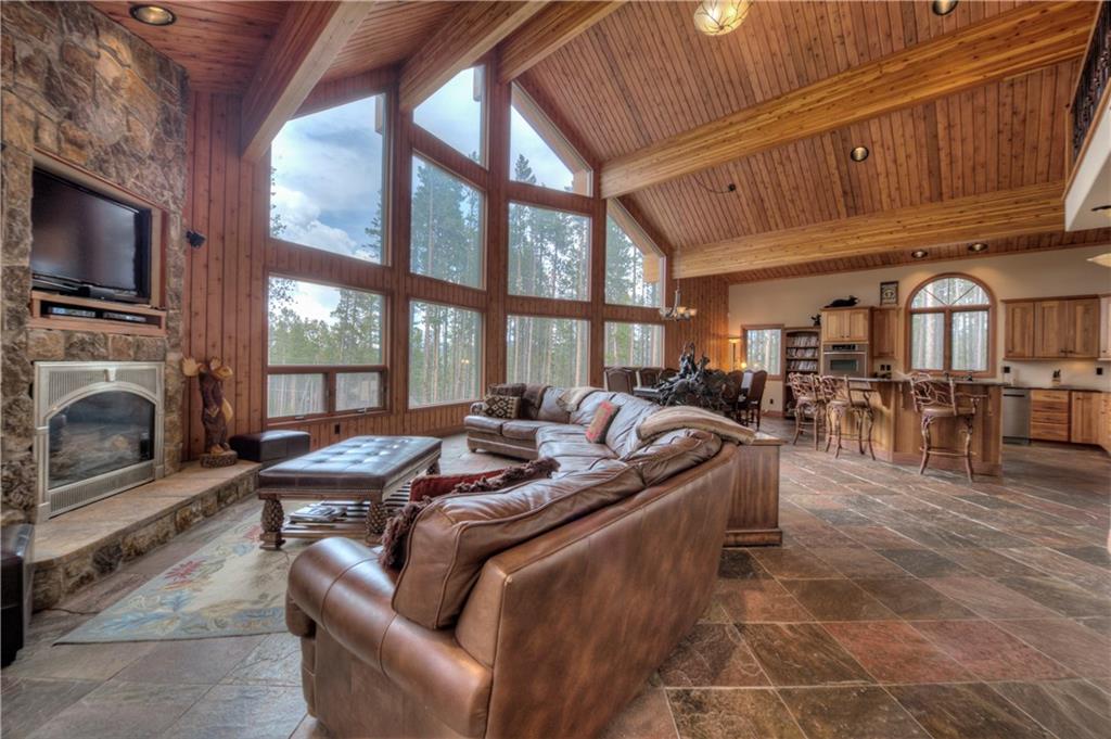 324 4 O'Clock Run Road Breckenridge, CO 80424 - Photo 2 of 25 a living room with furniture a fireplace and a flat screen tv