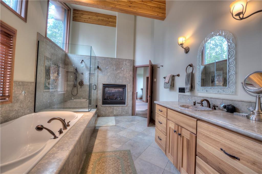 324 4 O'Clock Run Road Breckenridge, CO 80424 - Photo 12 of 25 a bathroom with a tub sink and mirror