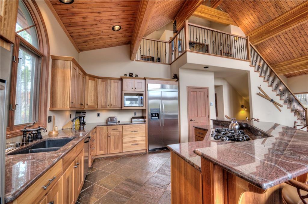 324 4 O'Clock Run Road Breckenridge, CO 80424 - Photo 3 of 25 a kitchen with stainless steel appliances granite countertop a sink a stove and a refrigerator