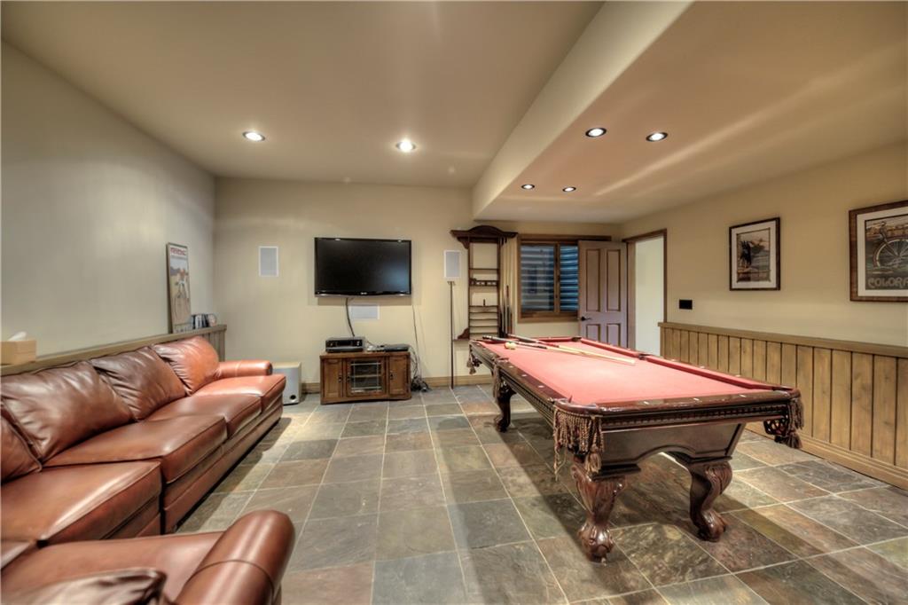 324 4 O'Clock Run Road Breckenridge, CO 80424 - Photo 21 of 25 a living room with furniture a flat screen tv and a chandelier