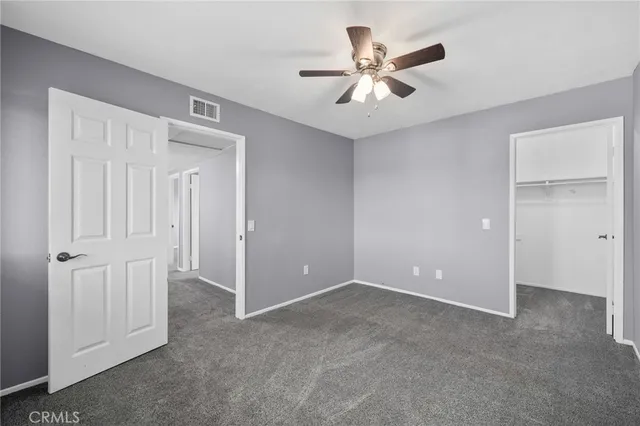an empty room with closet and entryway