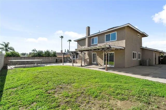 a view of a house with a yard and sitting area