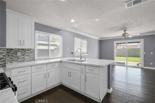 a kitchen with sink cabinets and wooden floor