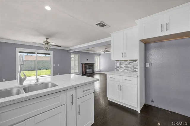 a kitchen with white cabinets and appliances