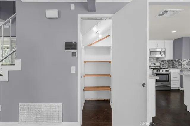a view of a kitchen with a refrigerator and a stove top oven