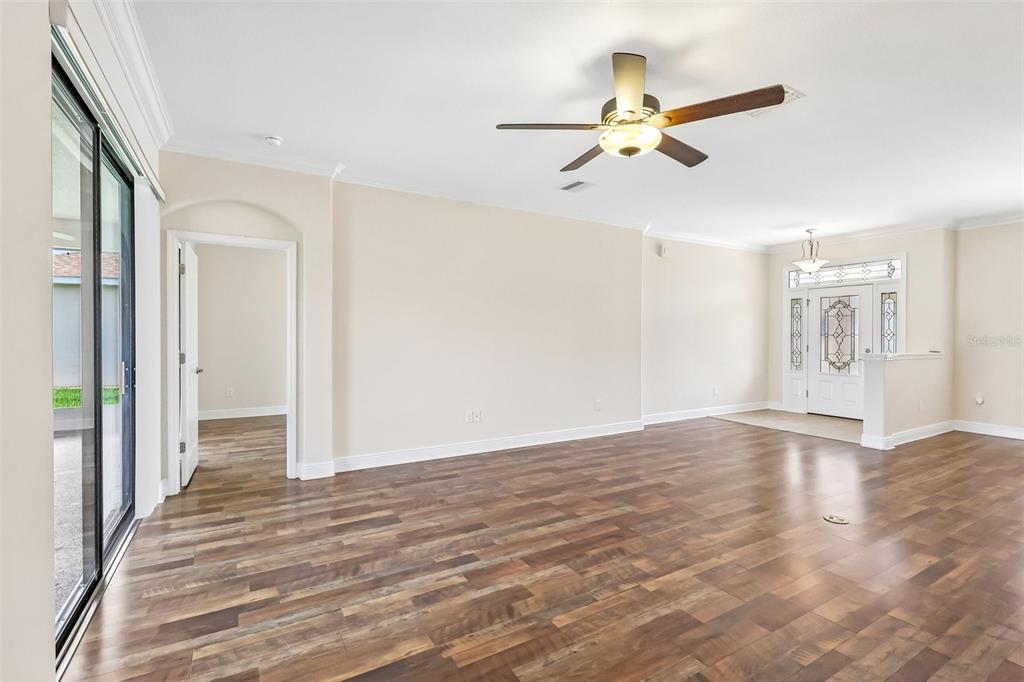 3522 Arlington Ridge Boulevard Leesburg, FL 34748 - Photo 11 of 43 a view of a livingroom with wooden floor and a ceiling fan