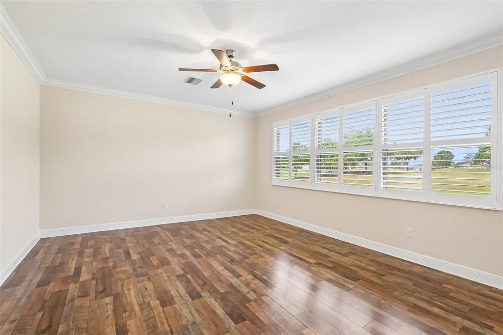 3522 Arlington Ridge Boulevard Leesburg, FL 34748 - Photo 13 of 43 an empty room with wooden floor fan and windows