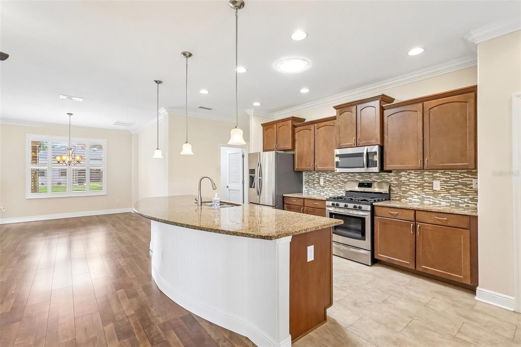 3522 Arlington Ridge Boulevard Leesburg, FL 34748 - Photo 15 of 43 a kitchen with stainless steel appliances granite countertop a sink stove and refrigerator