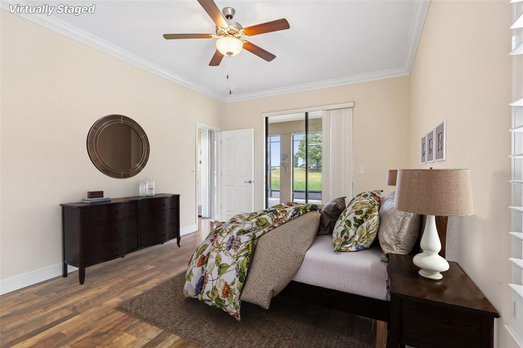 3522 Arlington Ridge Boulevard Leesburg, FL 34748 - Photo 19 of 43 a bedroom with bed and a chandelier
