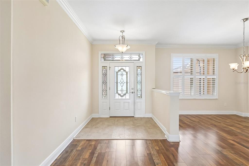 3522 Arlington Ridge Boulevard Leesburg, FL 34748 - Photo 4 of 43 an empty room with wooden floor cabinet and windows