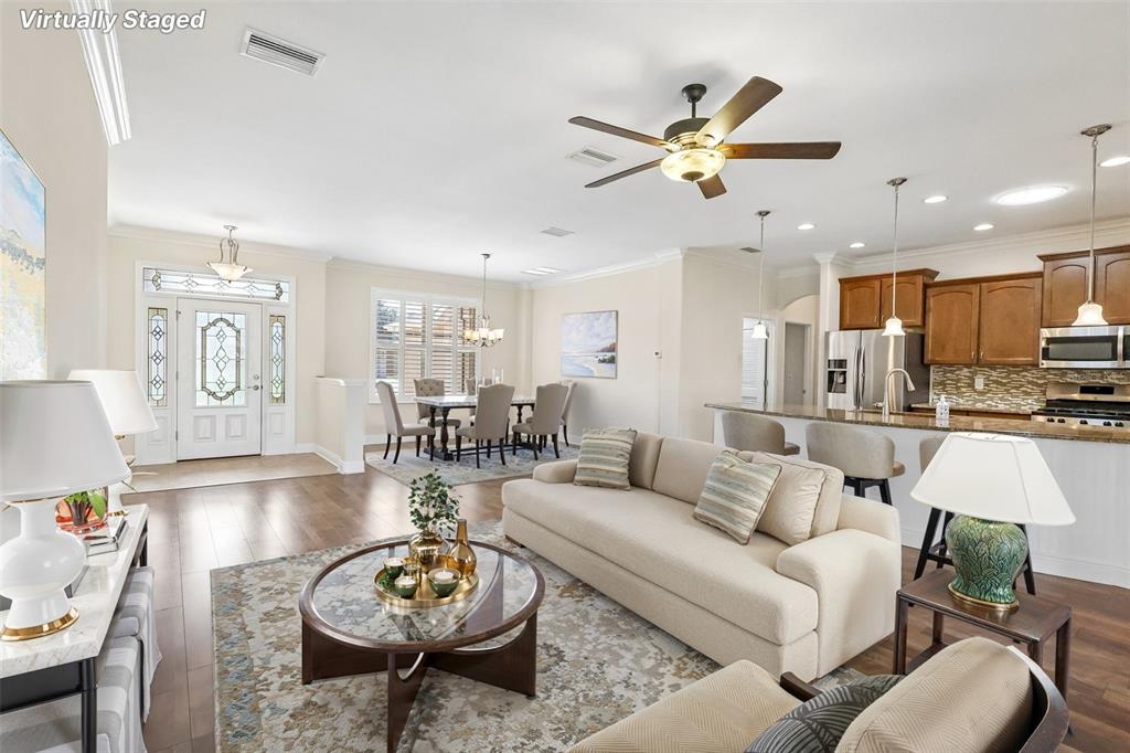 3522 Arlington Ridge Boulevard Leesburg, FL 34748 - Photo 7 of 43 a living room with furniture a table and kitchen view