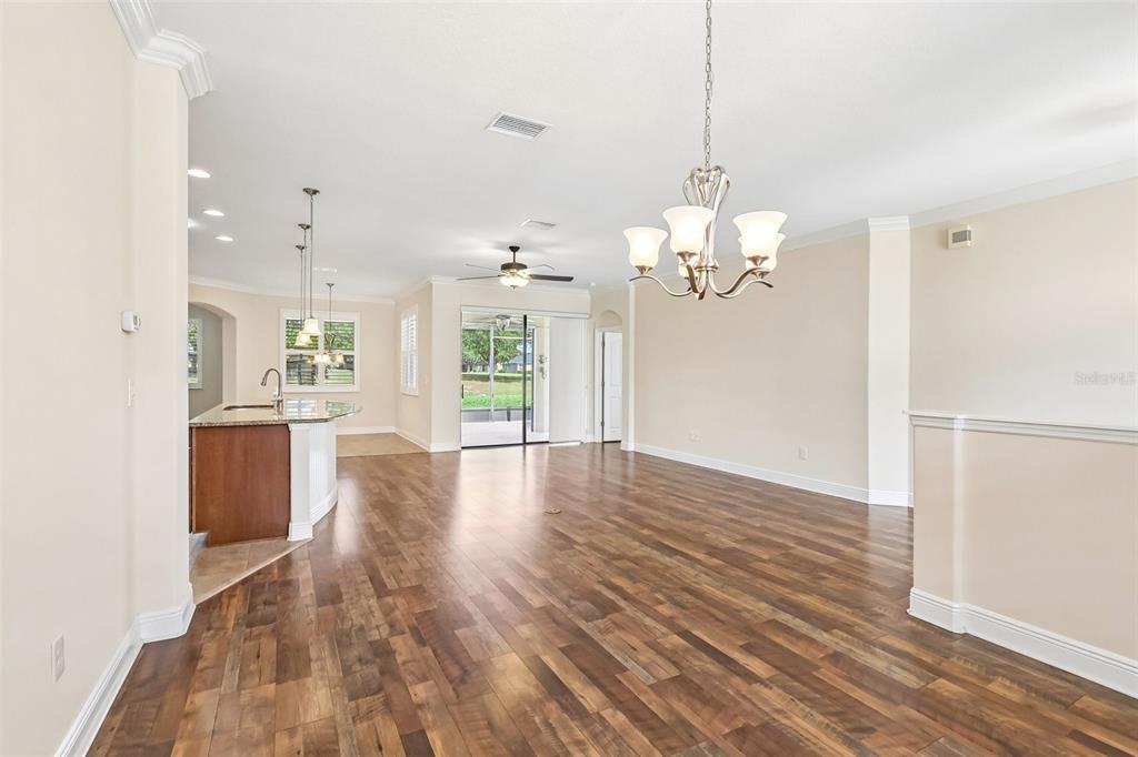 3522 Arlington Ridge Boulevard Leesburg, FL 34748 - Photo 10 of 43 a view of a kitchen with granite countertop wooden floor and a refrigerator