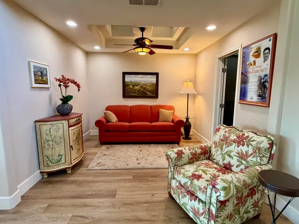 a bedroom with furniture and wooden floor