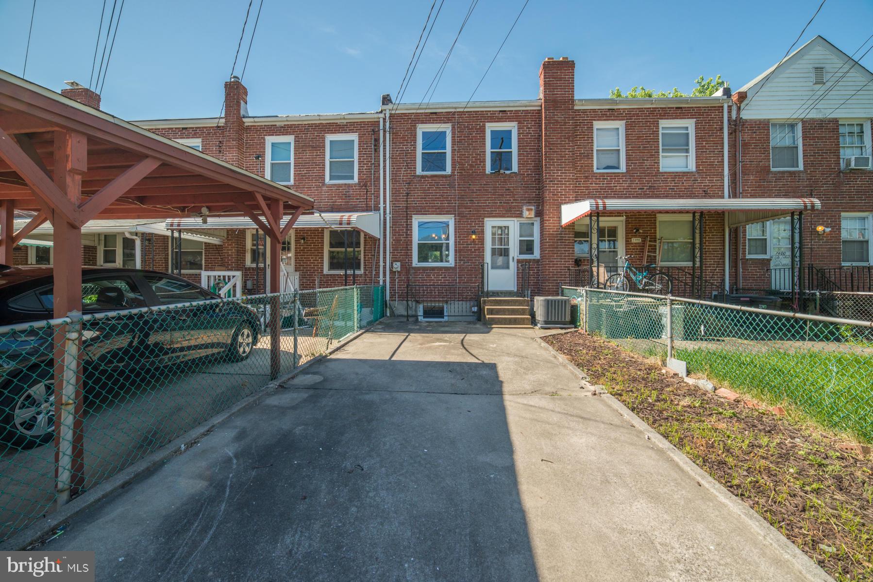 7404 Kirtley Road Baltimore, MD 21222 - Photo 12 of 13 a view of a brick house with a yard and plants