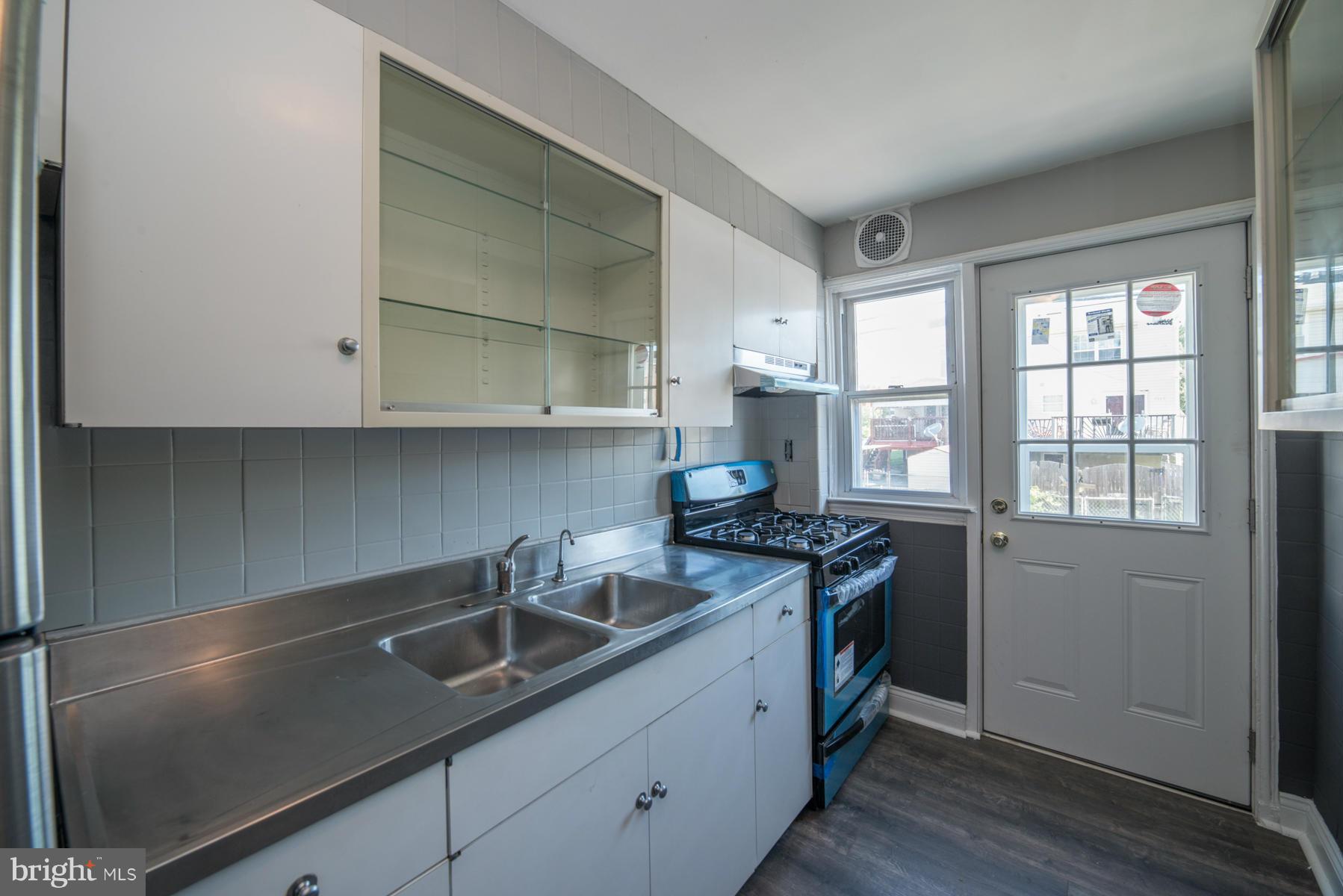7404 Kirtley Road Baltimore, MD 21222 - Photo 4 of 13 a kitchen that has a sink and a stove