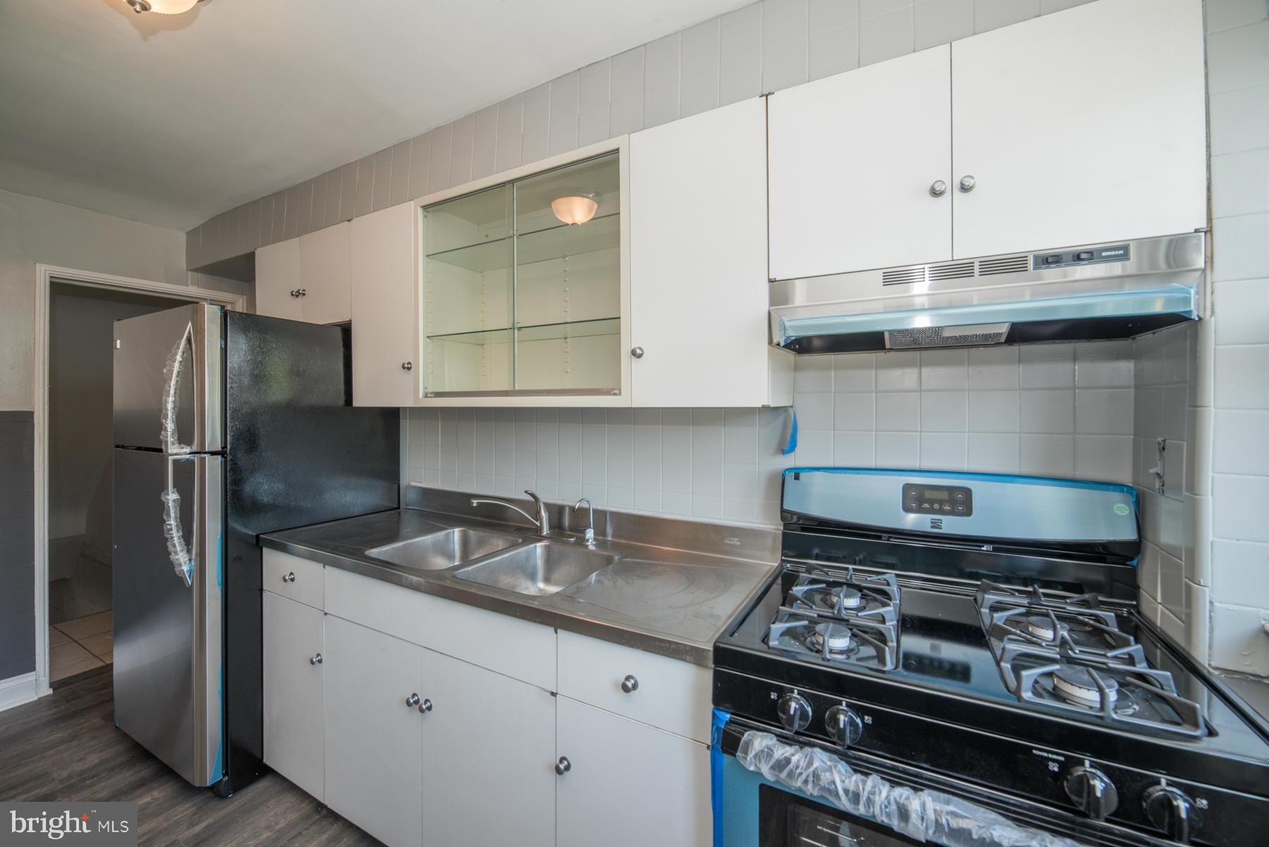 7404 Kirtley Road Baltimore, MD 21222 - Photo 5 of 13 a kitchen with stainless steel appliances granite countertop a stove and a refrigerator