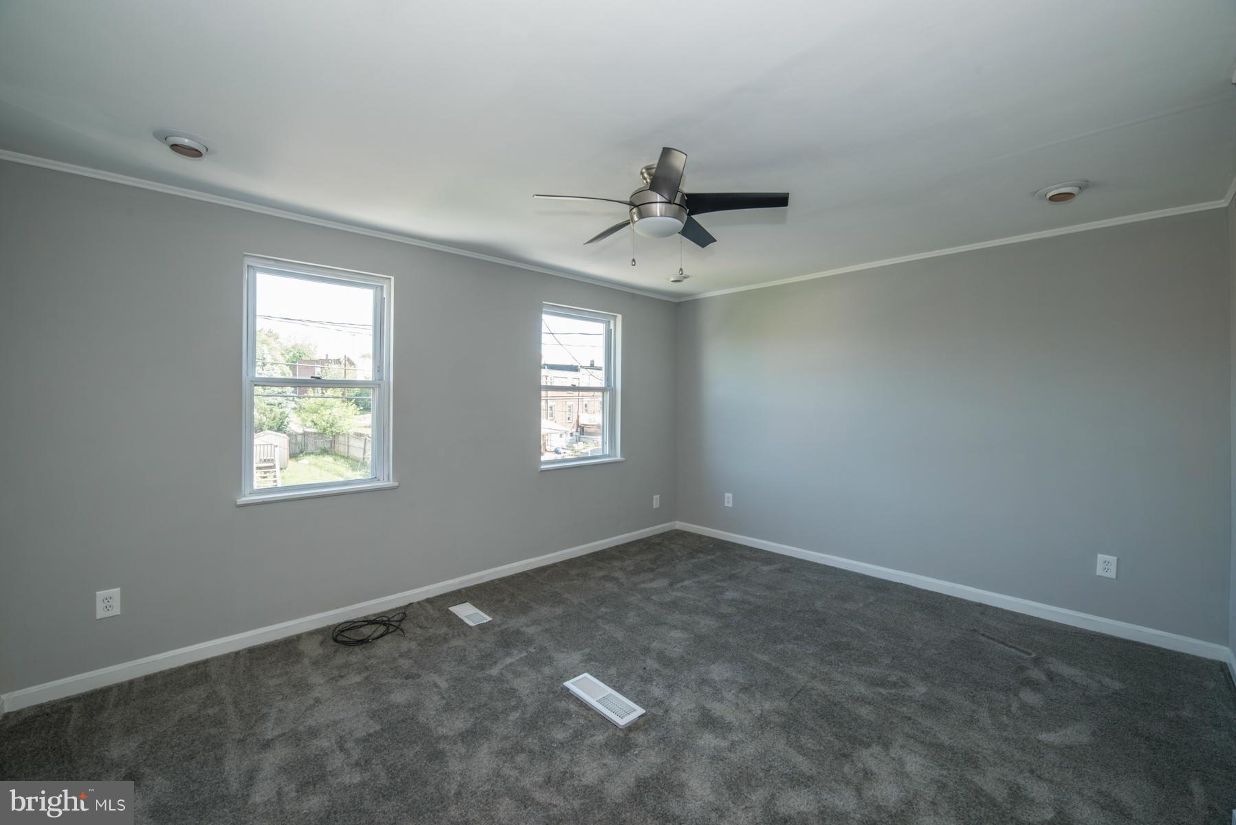 7404 Kirtley Road Baltimore, MD 21222 - Photo 7 of 13 a view of an empty room with a window