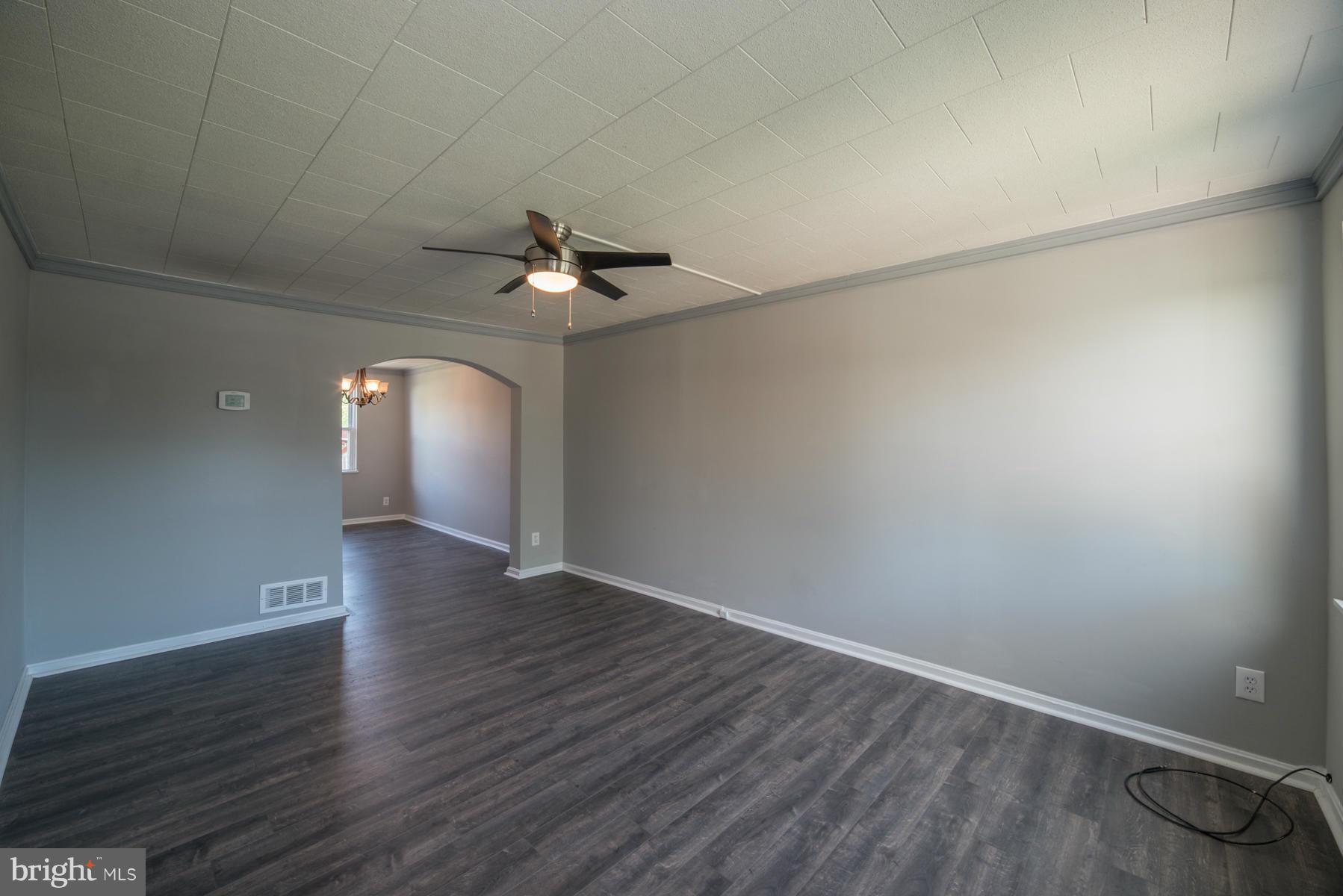 7404 Kirtley Road Baltimore, MD 21222 - Photo 8 of 13 a view of an empty room with wooden floor