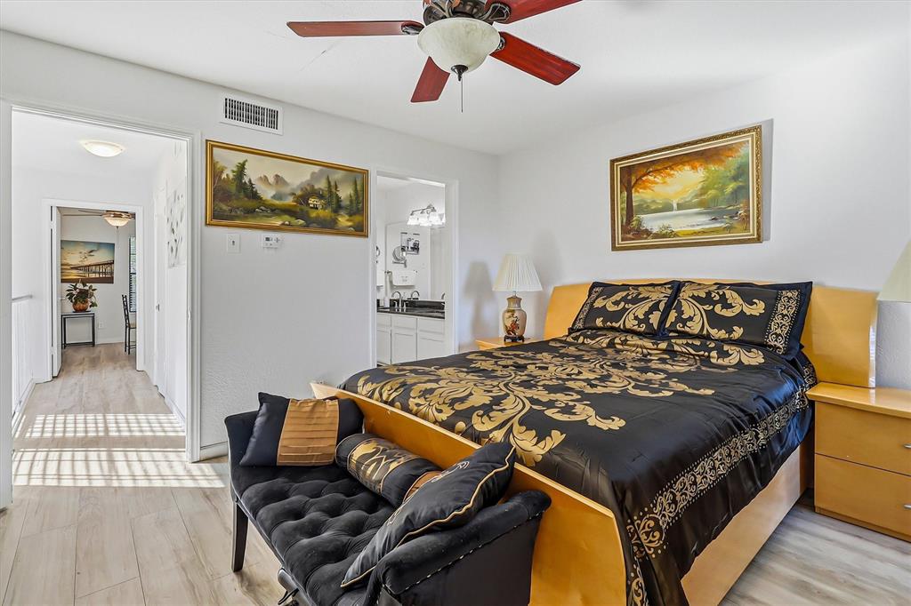 15151 Berry Trail, Unit 1307 Dallas, TX 75248 - Photo 17 of 27 Bedroom featuring light wood-type flooring, a ceiling fan, and ensuite bath