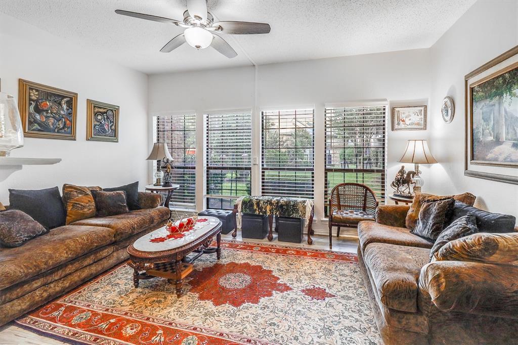 15151 Berry Trail, Unit 1307 Dallas, TX 75248 - Photo 6 of 27 Living room featuring a textured ceiling, wood finished floors, and a ceiling fan
