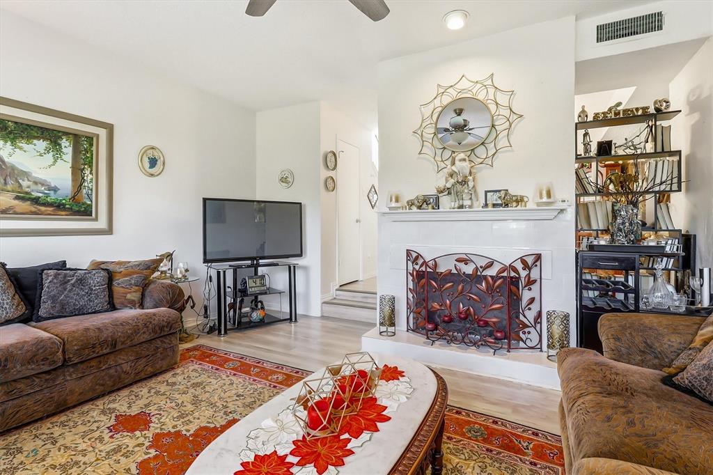 15151 Berry Trail, Unit 1307 Dallas, TX 75248 - Photo 8 of 27 Living area featuring wood finished floors and a ceiling fan