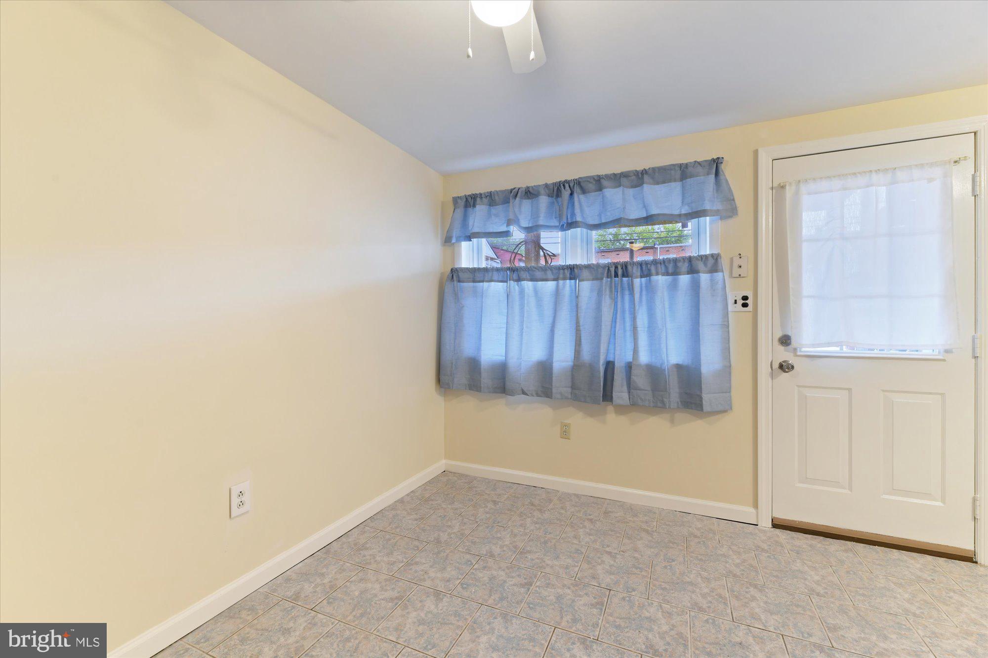 8051 Gray Haven Road Baltimore, MD 21222 - Photo 13 of 24 Full size windows in the kitchen/walk up basement