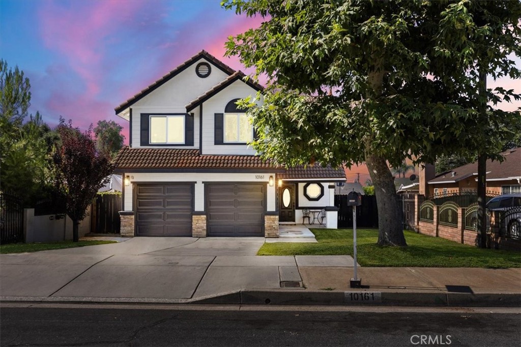 10161 24th Street Rancho Cucamonga, CA 91730 - Photo 1 of 1 a front view of a house with a garden and garage