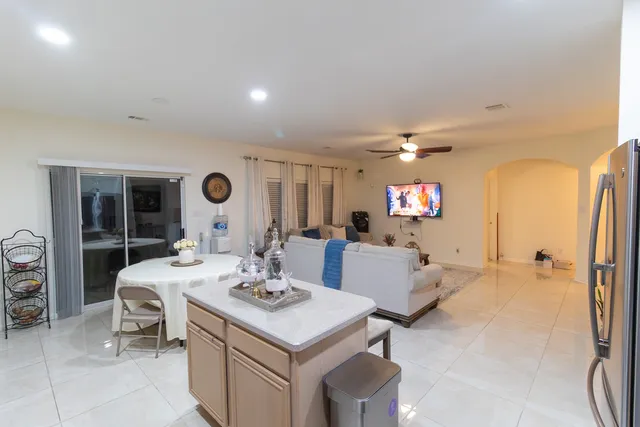 a view of a very nice looking dining room with a table and chairs