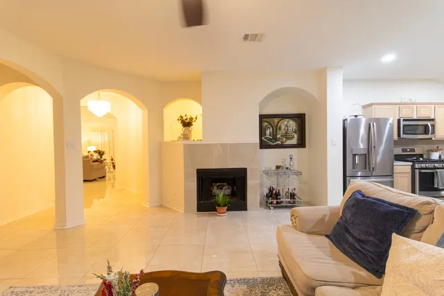 a living room with furniture and a fireplace