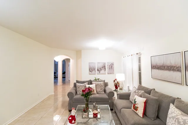 a living room with furniture and a painting on the wall