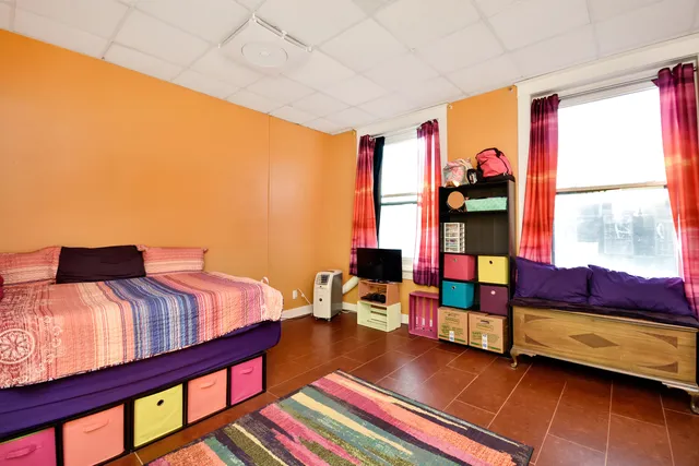 a bedroom with furniture and a window