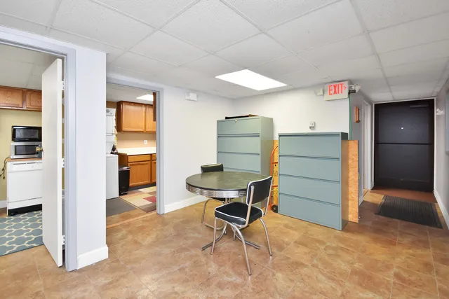 a living room with furniture and a floor to ceiling window