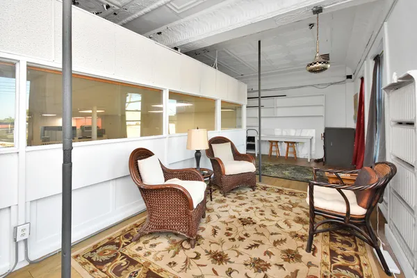 a living room with lots of furniture and a large window