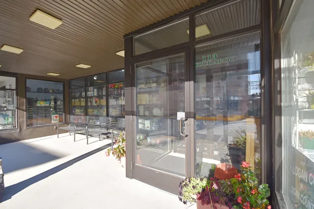 a room with lot of potted and glass door