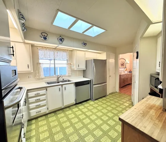 a kitchen with a sink stove and cabinets