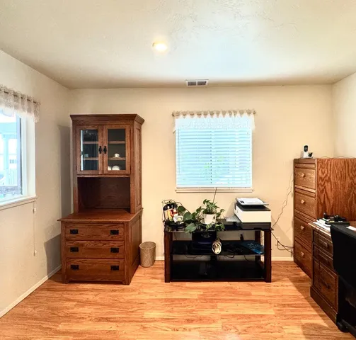 a utility room with dryer washer and a view of kitchen