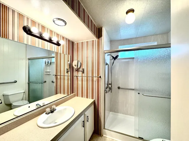 a bedroom with a bed and a mirror