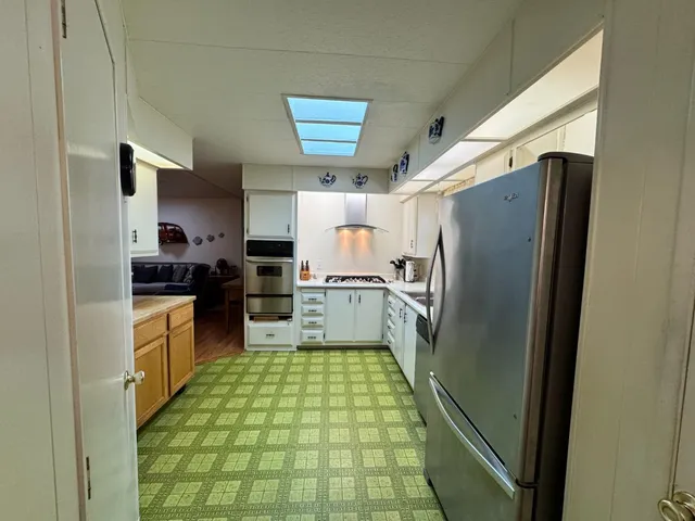 a kitchen with stainless steel appliances granite countertop a sink and cabinets