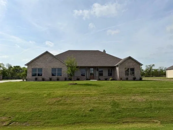 a big house with a big yard and large trees
