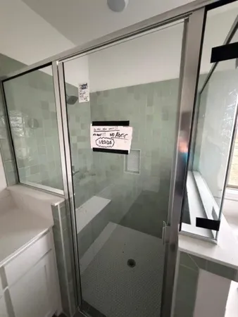 a bathroom with a shower and a sink