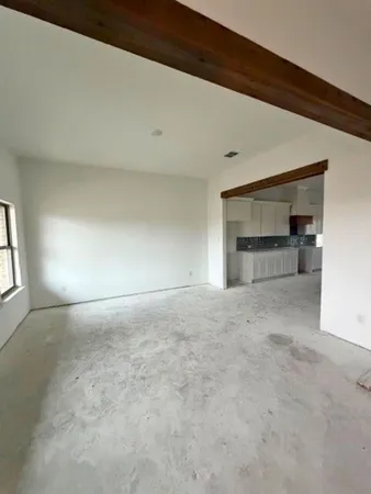 a view of empty room with a fireplace