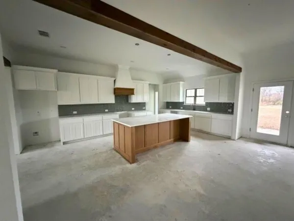 a large kitchen with cabinets and a counter top space